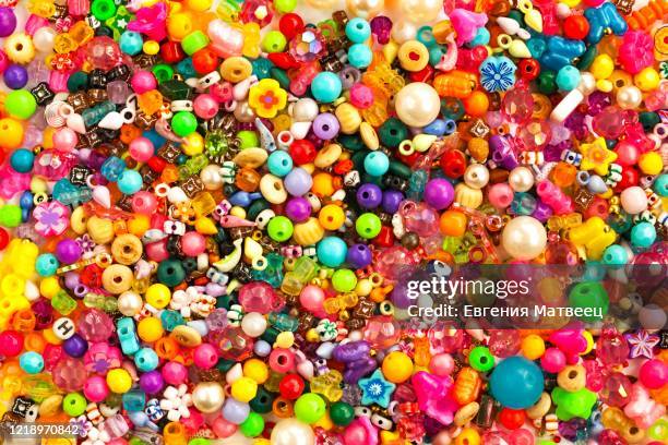 multicolored beads background. mix of shiny different size, shape jewelry glass and plastic bead. - costume jewelry fotografías e imágenes de stock