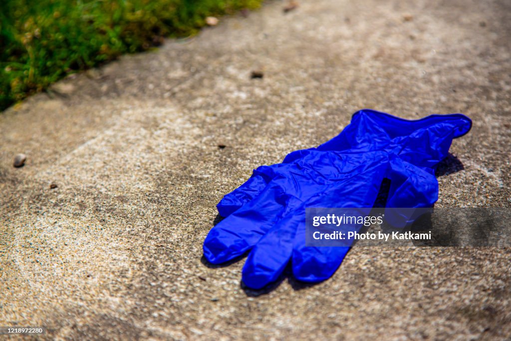 Used glove on pavement