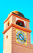 Clock tower of Church of Santo Stefano on Capri Island reflex