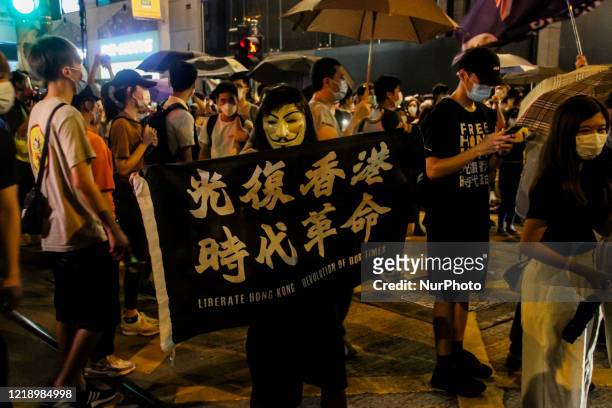 Protester holds up a flag during the one-year anniversary of the Hong Kong protests, during the 9th June street demonstrations, Central, Hong Kong.