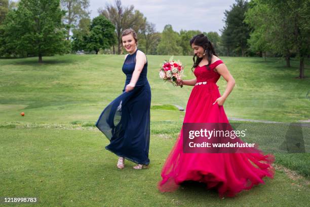 best friends dancing on the lawn before prom - prom stock pictures, royalty-free photos & images