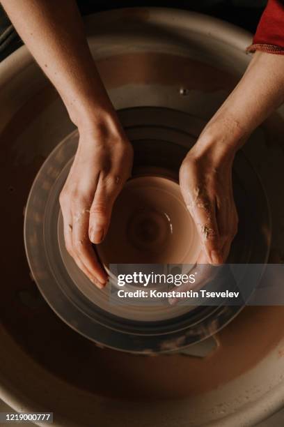 woman making ceramic work with potter's wheel. - pottery wheel stock pictures, royalty-free photos & images