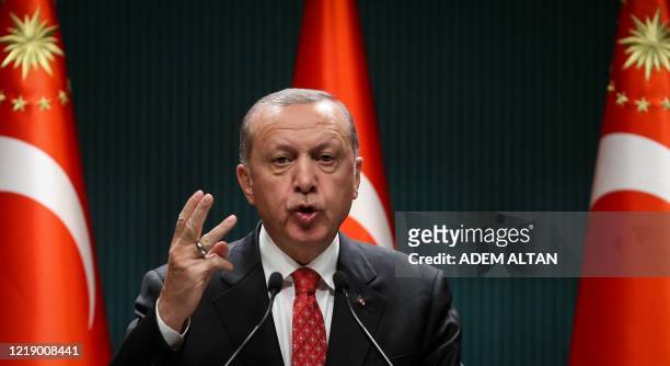Turkish President Recep Tayyip Erdogan gestures as he delivers a speech following a cabinet meeting, in Ankara, on June 9, 2020.