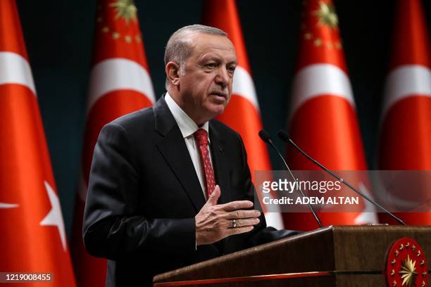 Turkish President Recep Tayyip Erdogan gestures as he delivers a speech following a cabinet meeting, in Ankara, on June 9, 2020.