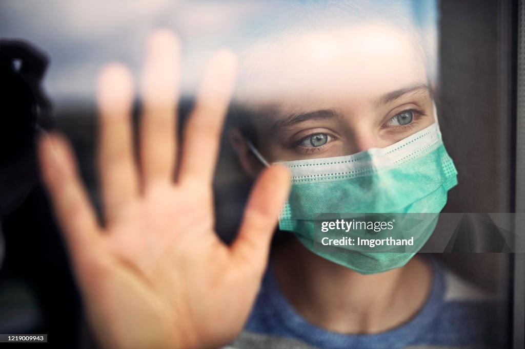 Sad teenage girl staying at home during COVID-19 quarantine