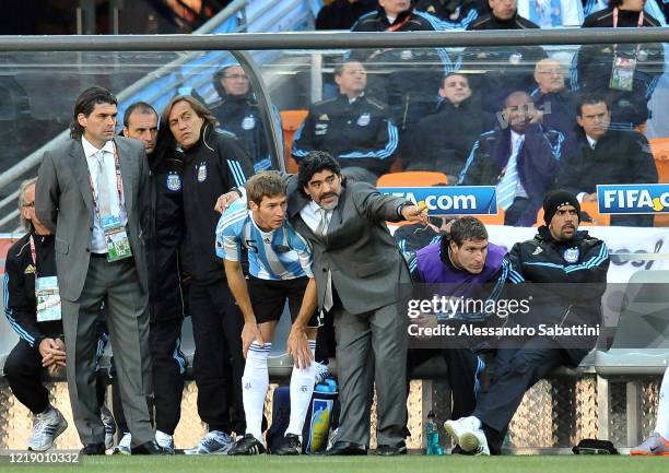 Diego Armando Maradona head coach of Argentina issues instructions to his player Mario Bolatti of Argentina during the FIFA World Cup 2010 Group B...