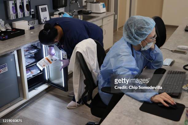 Velocity Urgent Care operations coordinator Keyana Joseph of Virginia Beach stores coronavirus tests in a refrigerator as Nurse Practitioner Diane...