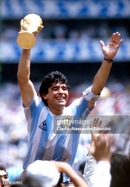 Diego Armando Maradona of Argentina celebrates the victory with the world cup at the end the FIFA World Cup Final 1986 match between Argentina and...