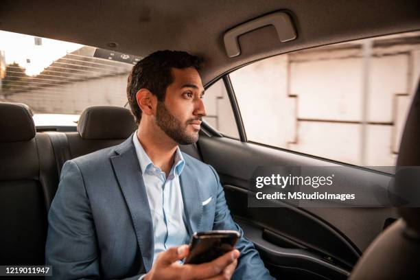 businessman using mobile ph - indian ethnicity man car stock pictures, royalty-free photos & images