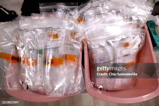 Testing kits for the novel coronavirus are stacked at the Velocity Urgent Care April 15, 2020 in Woodbridge, Virginia. Able to test about 100...