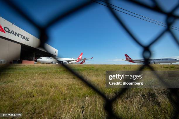 Grounded Qantas Airways Ltd. Aircraft stand outside a hangar at Brisbane Airport in Brisbane, Australia, on Tuesday, June 9, 2020....