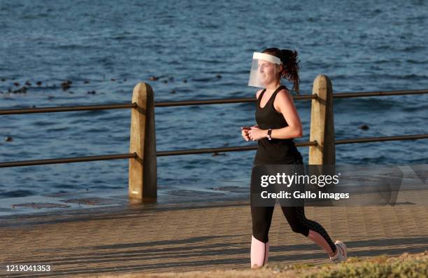 Woman wearing a face shield seen running at the promenade in Sea Point on June 09, 2020 in Cape Town, South Africa. The Western Cape accounts for...