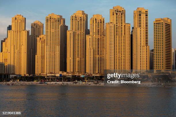 Residential towers stand in the Jumeirah Beach Residence district in Dubai, United Arab Emirates, on Monday, June 8, 2020. An exodus of middle class...