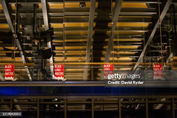 Person walks by Black Lives Matter signs inside Seattle City Hall after demonstrators marched inside led by Seattle City Council member Kshama Sawant...