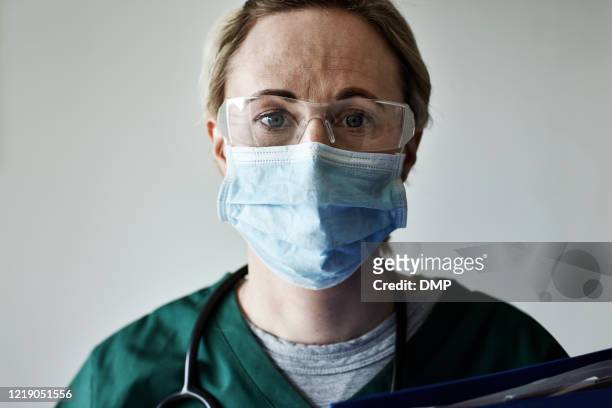 we're faced with a serious and deadly pandemic - face mask protective workwear stock pictures, royalty-free photos & images