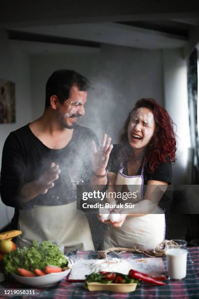 couple having fun in the kitchen, stay at home, quarantine activity at home - messy kitchen stock pictures, royalty-free photos & images