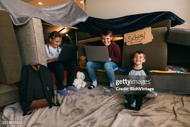 children homeschooling in a couch fort - covid quarantine stock pictures, royalty-free photos & images