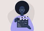 Movie production, young female character holding a clapper board, video industry