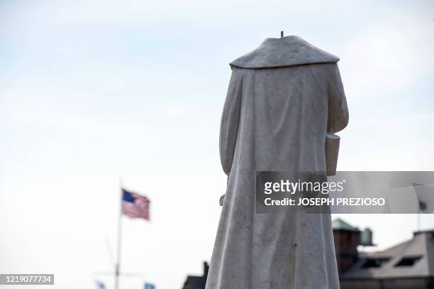 Decapitated statue of Christopher Columbus is viewed at Christopher Columbus Park in Boston Massachusetts on June 10, 2020. - The statue's head,...