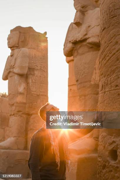 young man lost in karnak temple, luxor, egypt - daily life in egypt stock pictures, royalty-free photos & images