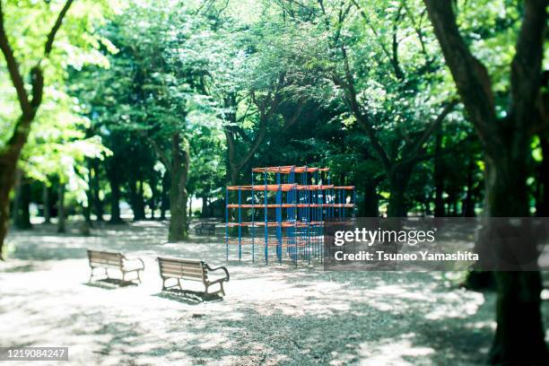 park with playground equipment - outdoor play equipment stock pictures, royalty-free photos & images