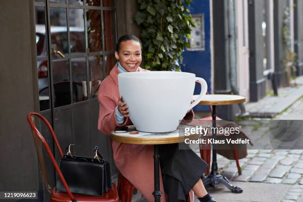 Smiling Woman With Large Coffee Cup At Sidewalk Cafe High-Res Stock Photo -  Getty Images