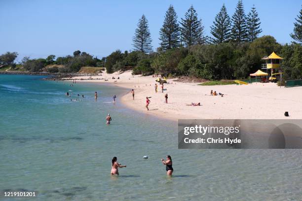 Beach goers enjoy Tallebudgera creek on April 16, 2020 in Gold Coast, Australia. The Federal Government has closed all non-essential business and...