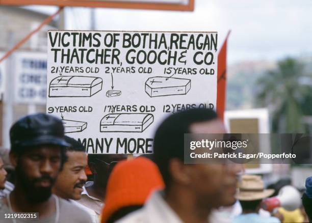Protesters display anti-apartheid slogans on banners during the 2nd One Day International between West Indies and England at Queen's Park Oval, Port...