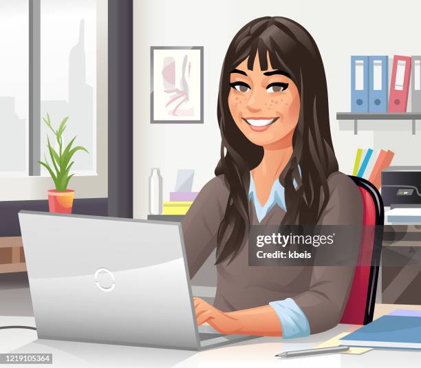 young woman working on laptop in office - freckle stock illustrations