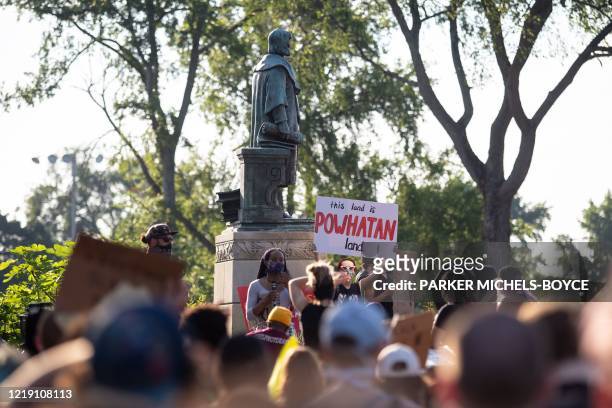 Protesters surround a statue of Christopher Columbus before marching, eventually returning and pulling it down in Richmond, Virginia, June 9, 2020. -...