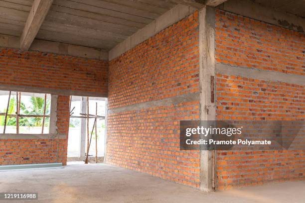 construction site with brick wall on construction building. concept of building a house with bricks. - knife block stock-fotos und bilder