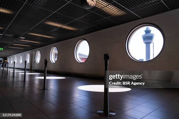 The control tower is seen through a window in the hallway at a deserted looking Schiphol Amsterdam Airport following the continued intelligent...