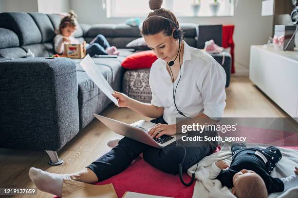 ocupada madre soltera trabajando en casa y niñera - multitareas fotografías e imágenes de stock