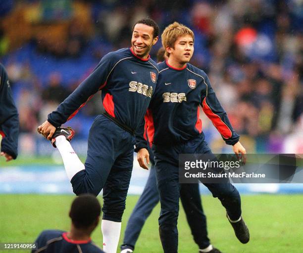 Thierry Henry and Junich Inamoto of Arsenal warm up before the Premier League match between Everton and Arsenal on February 10, 2002 in Liverpool,...