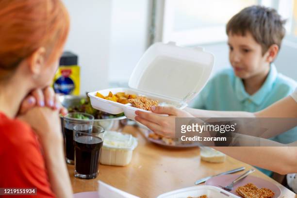 mother with her children having take out food at home - battered child syndrome stock pictures, royalty-free photos & images