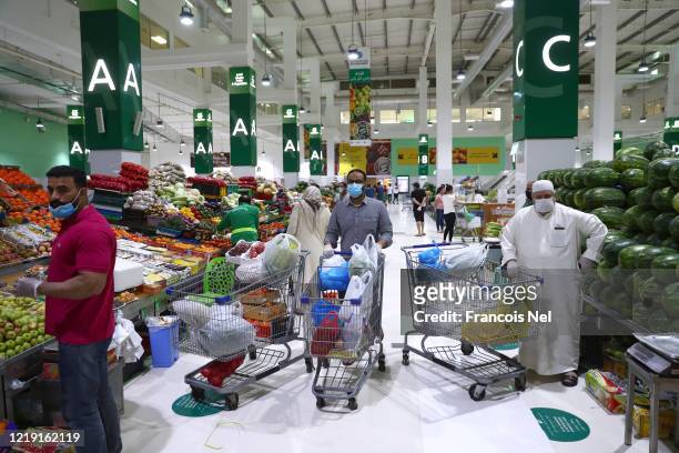 People buy fresh fruit and vegetables at the Waterfront Market on April 16, 2020 in Dubai, United Arab Emirates. The Coronavirus pandemic has spread...