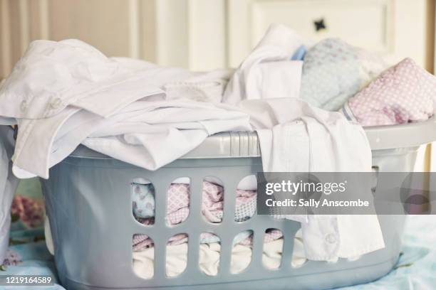 washing basket full of clothes - vestito bianco foto e immagini stock