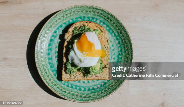 poached egg, avocado on toast - egg stock pictures, royalty-free photos & images