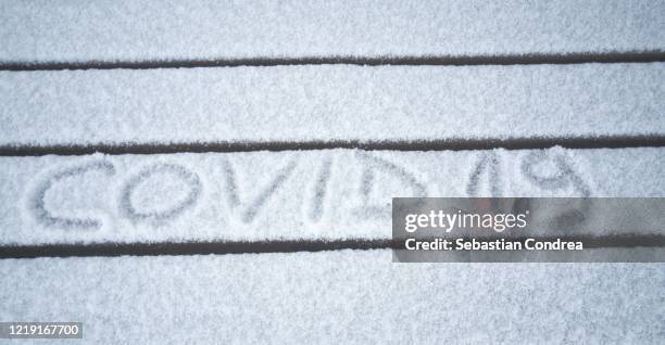 inscription - covid-19 the virus made on snow texture. - coronavirus winter stock-fotos und bilder