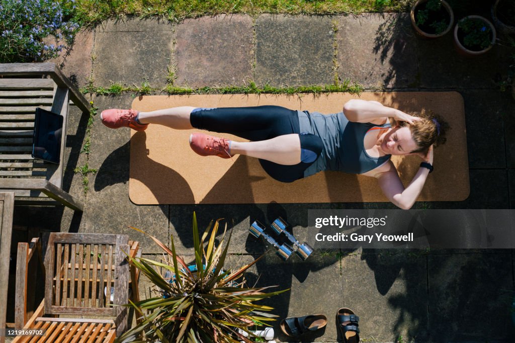 Woman exercising in her garden