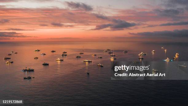 majestic sunset view showing a group of super yachts moored in the bay, monaco - yate de lujo fotografías e imágenes de stock