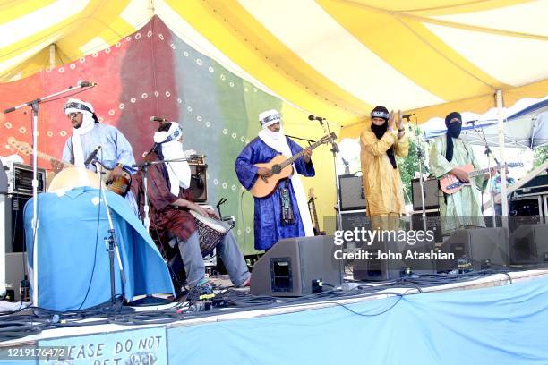 Tinariwen, a band of Tuareg-Berber musicians from the Sahara Desert region of northern Mali, are shown performing on stage during a "live" concert...