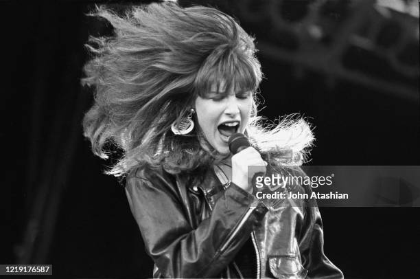 Singer Tiffany is shown performing on stage during a "live" concert appearance on August 13, 1989.