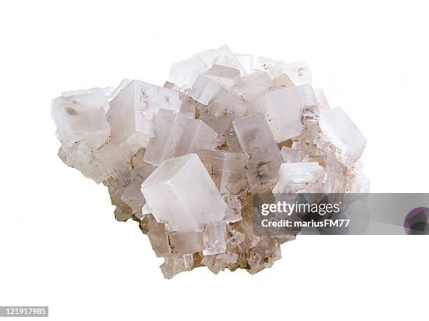 close-up of rock salt against white background - zout mineraal stockfoto's en -beelden