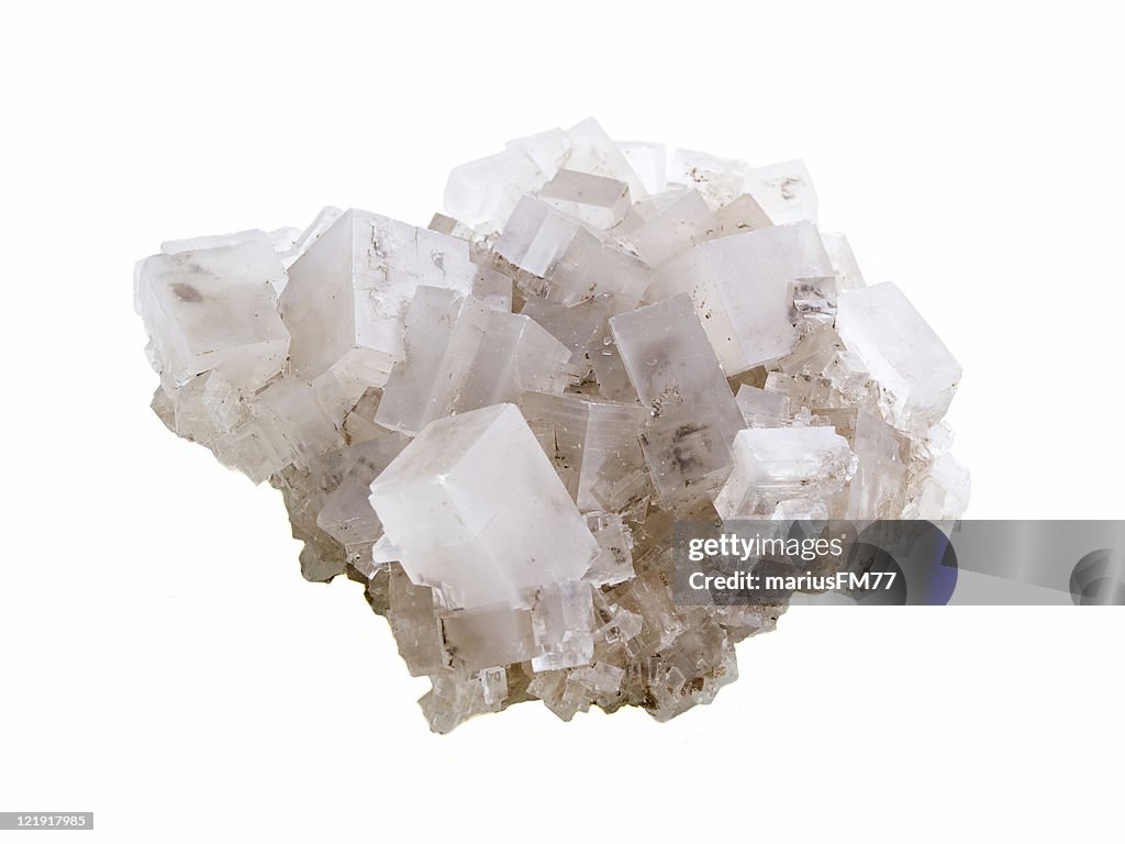Close-up of rock salt against white background
