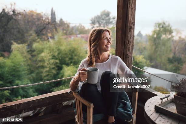 young woman drinking coffee at home - coffee on patio stock pictures, royalty-free photos & images