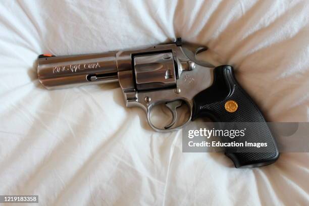 Colt King Cobra .357 magnum pistol, gun pointed left on neutral background.