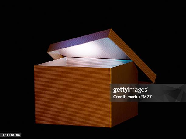 brown box with soft glowing light inside - mystery stock pictures, royalty-free photos & images