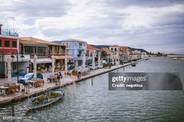 promenade of lefkada with different colorful houses in levkas, greece - lefkada city stock-fotos und bilder