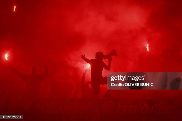 Partizan supporters cheer and light flares during the Serbian Cup semi-final football match between FK Partizan Belgrade and Red Star Belgrade at the...